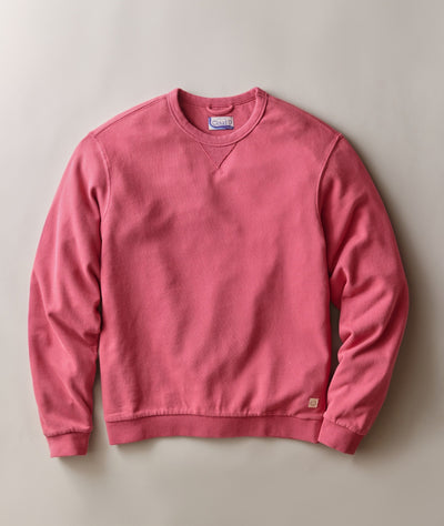 A dusty rose pink super soft crewneck sweatshirt laid flat against a neutral light gray background with full length sleeves